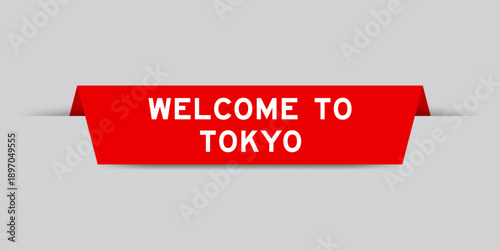 Red color inserted label with word welcome to tokyo on gray background