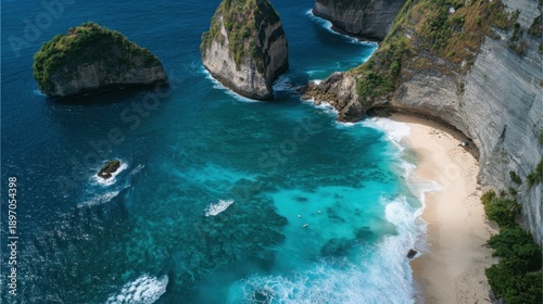 Aerial view of pristine beach with turquoise waters and rocky cliffs.