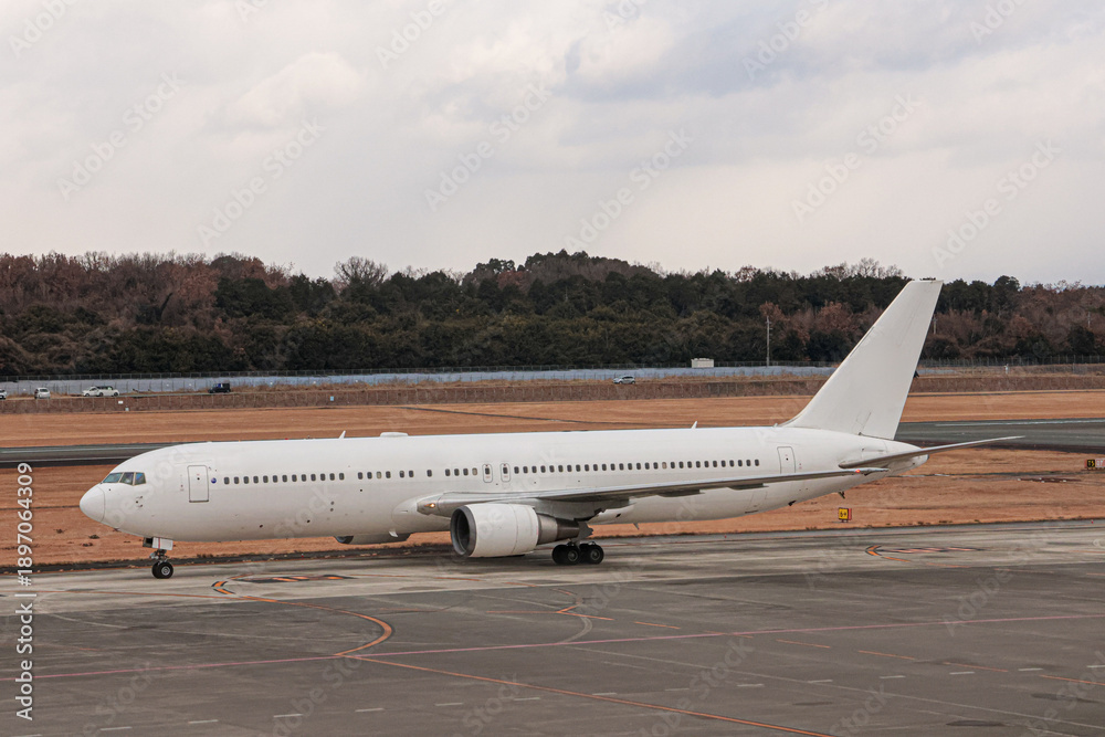 Fototapeta premium Passenger Aircraft Waiting at Kumamoto Airport in Winter
