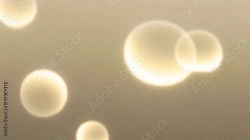 Abstract bubbles floating in soft golden light background  