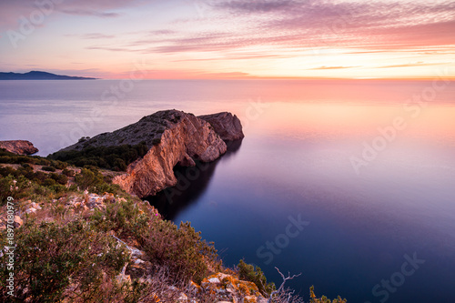 Colorful sea sunrise on the rocky coastline