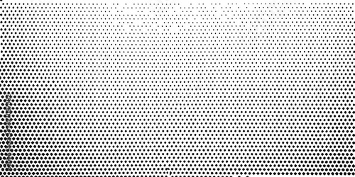A grayscale halftone pattern transitioning from dark to light