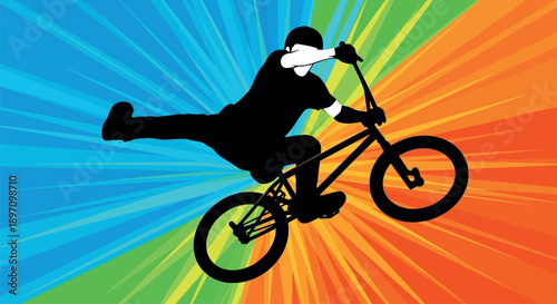 A silhouette of a person performing a trick on a bicycle against a vibrant colorful background