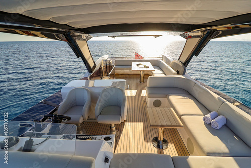 A boat with a white canopy and a blue sky in the background