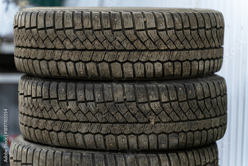 A stack of winter tires stacked on top of each other