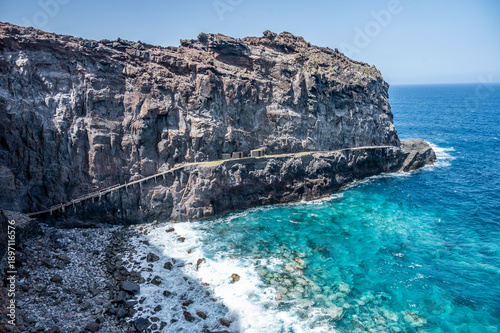 Old wooden bridge at a cliff at the sea on Madeira island