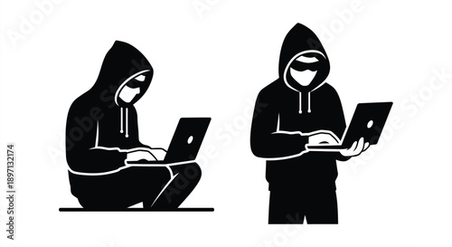 Two hooded figures working on laptops a striking silhouette