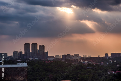Canvas Print Silhouetted buildings of Kuala Lumpur, Malaysia under a moody sunset sky