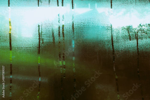 This is wet condensation on a window on a cold, dark winter day.