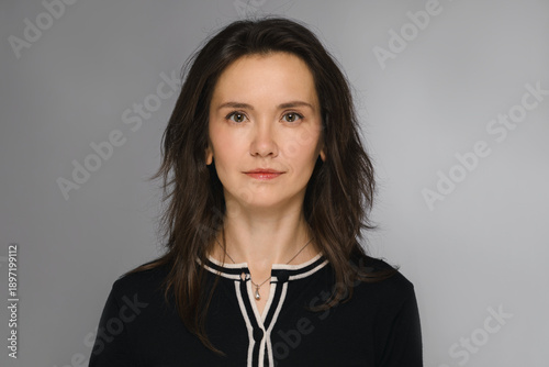 Portrait of a beautiful European woman in elegant clothing. 45 years old. Studio photo.