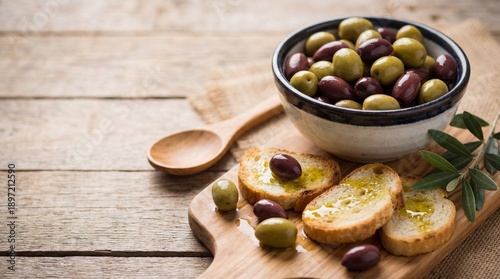 Warm Mediterranean Olives and Toasted Bread on Rustic Wooden Table