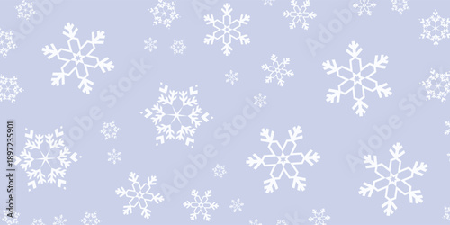 Seamless Pattern of White Snowflakes on a Light Blue Background.