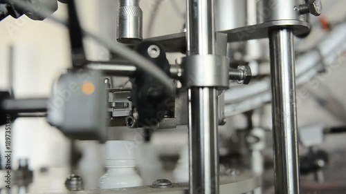 small bottles are moving on conveyor