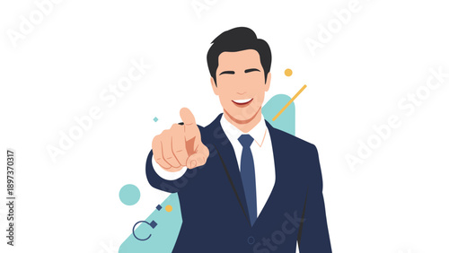 Confident young businessman in a dark blue suit pointing forward at the viewer with a friendly and happy smile.