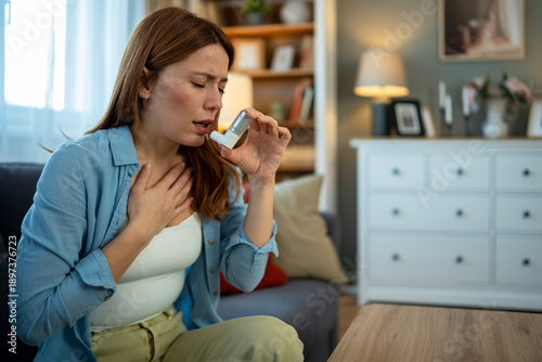 Bild auf Leinwand Woman experiencing asthma attack using medical inhaler