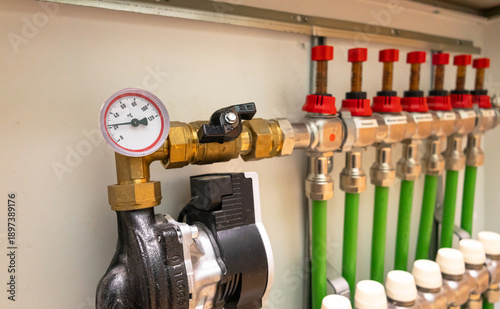 Cuadro en lienzo A modern domestic hydronic underfloor heating manifold with pipes, valves, flow meters, and a circulation pump