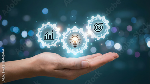 A human hand presenting three glowing gears with icons for business growth new ideas and strategic objectives on a dark digital bokeh background