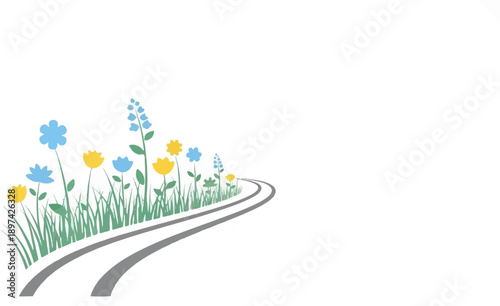 A winding grey path bordered by green grass and colorful blue and yellow flowers