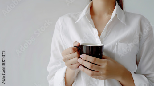 Elegant woman holding cup of coffee