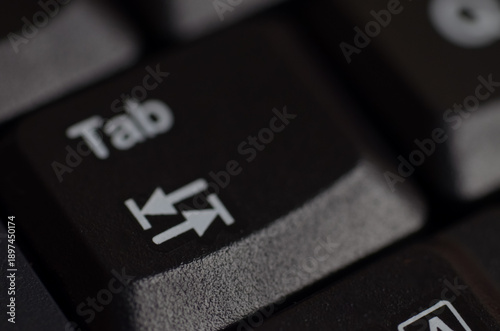 Photos Close-up of black Tab key with white text and bidirectional arrows, representing navigation and formatting in computing