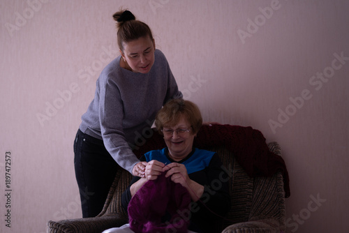 Elderly woman knitting in a chair