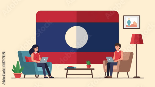 Two people working on laptops in a living room with a national flag as backdrop