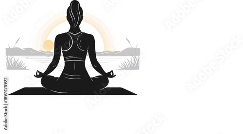 Silhouette of a woman in a lotus pose meditating outdoors at sunrise