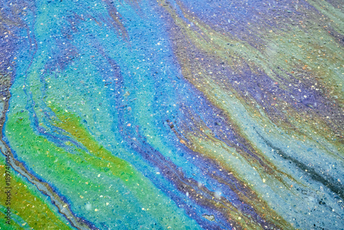 Bild auf Leinwand Iridescent oil slick creating abstract rainbow patterns on wet asphalt