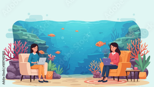 Two women work on laptops near an underwater scene with fish and coral