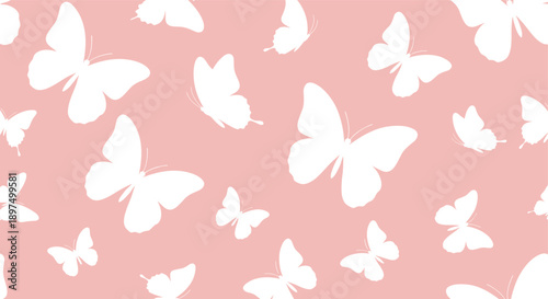 Elegant seamless pattern of white butterfly silhouettes in various sizes and angles floating over a soft pastel pink background area.