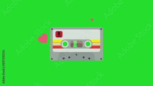 Animation of vintage cassette with heart symbol on green background