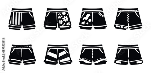 Stylish variety of black and white men's shorts on dark background