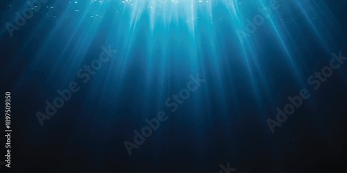 Sunlight beams penetrating deep blue water surface create an ethereal underwater scene
