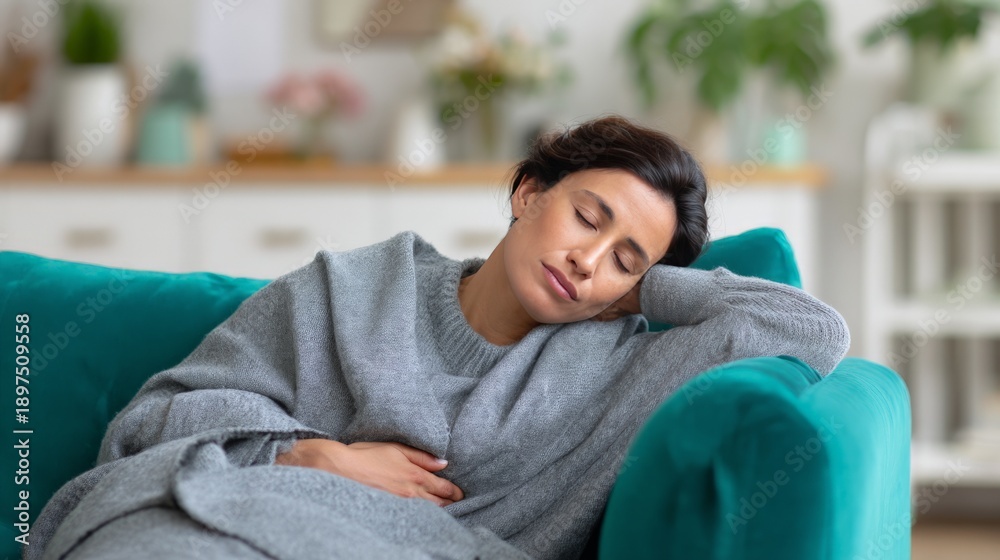 Fototapeta premium Asian female resting on sofa in cozy living room