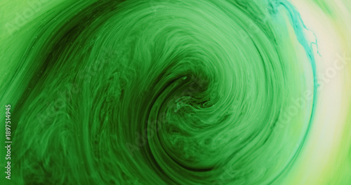 Ink whirl. Smoke twirl texture. Defocused green blue yellow color glitter vibrant fume bright round mist fog twirl on abstract background.