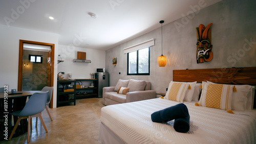 Tableau sur toile Studio apartment showcasing a contemporary design with a comfortable bed, a smal
