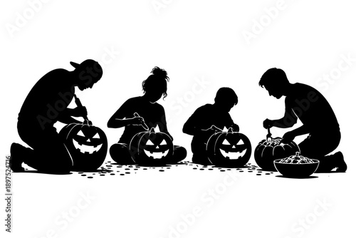 Silhouette of group carving halloween pumpkins together.