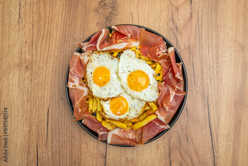 Slika na platnu Broken eggs with ham and caramelized onions, where the sweet onions mingle with