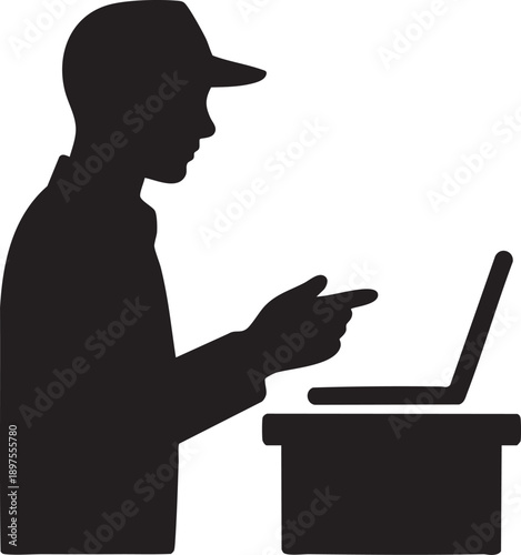Silhouette of a person wearing a cap, intently pointing towards an open laptop computer placed on a surface, symbolizing digital interaction, instruction, and modern workplace technology engagement