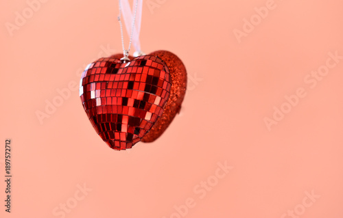 Hearts on peach color background, St. Valentines Day holiday 