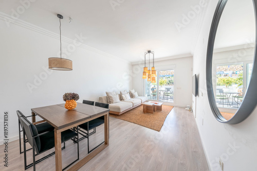 a luxury living and dining room area in mediterranean rental home with table and sofa