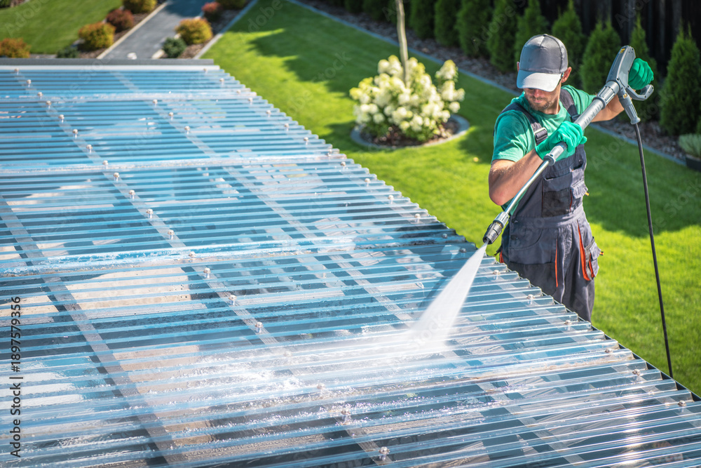 Fototapeta premium Worker Uses Pressure Washer Outdoors