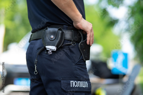 Ukrainian patrol police officer in dark blue trousers with 