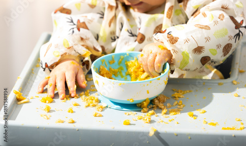 Baby exploring food during messy mealtime BLW