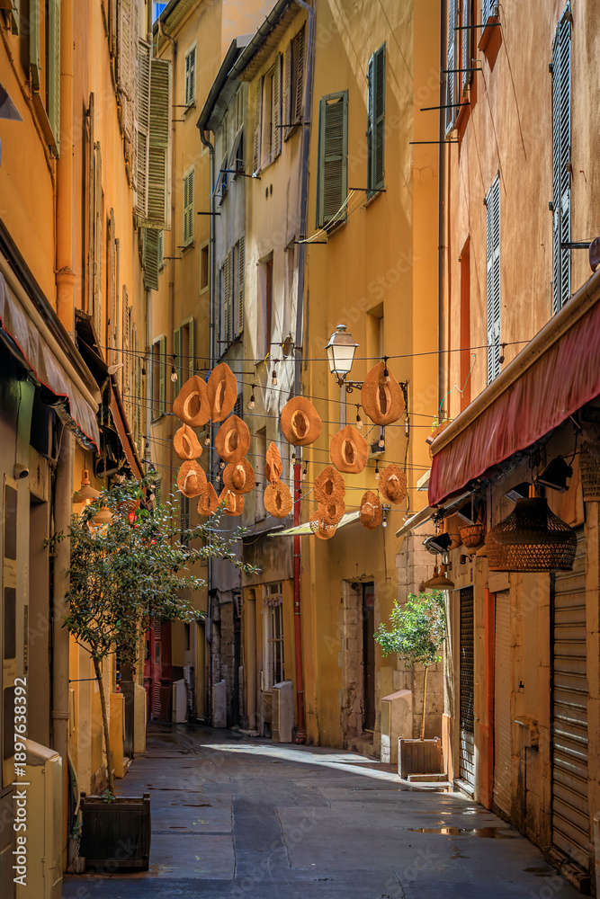 Fototapeta premium Colorful traditional houses line a narrow street in the Old Town of Nice, France