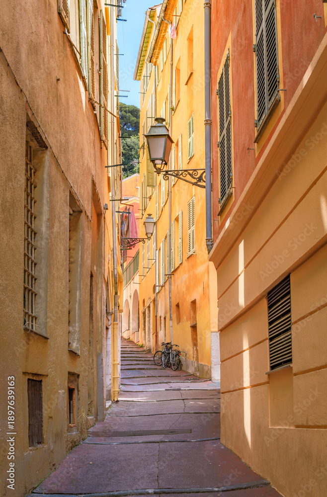 Obraz premium Colorful traditional houses line a narrow street in the Old Town of Nice, France