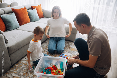 Bild auf Leinwand Family plays with toys in living room during daytime activities together