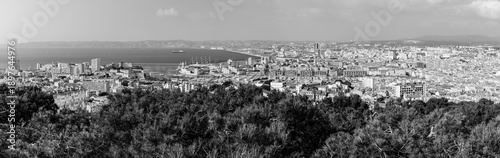 Panoramic aerial view od Marseille old port and its Mediterranean coastline; famous travel landmark city skyline of Marseille, Provence, France in black and white
