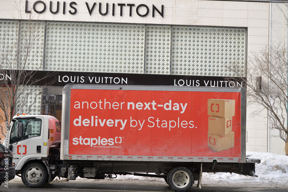 Fototapeta premium Staples delivery vehicle in front of Louis Vuitton, a leather goods store, located at 150 Bloor St W inside 89 Avenue Yorkville, Toronto