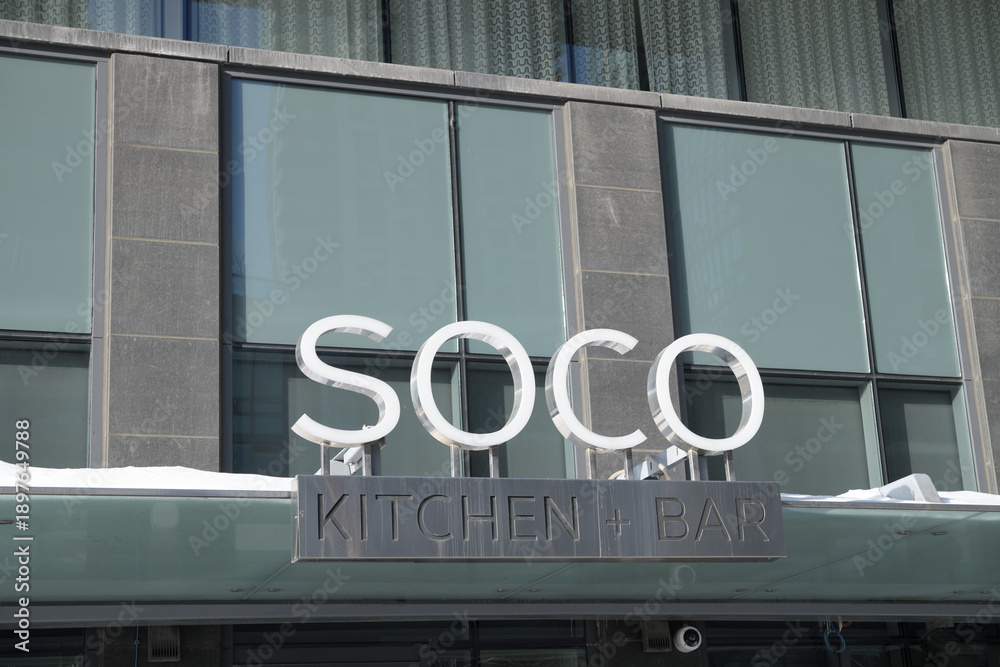 Fototapeta premium exterior building facade and sign of SOCO Kitchen + Bar, located inside Delta Hotel, 75 Lower Simcoe St, Toronto